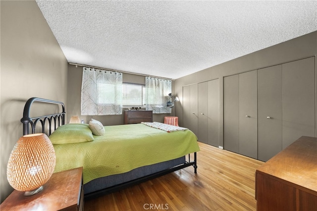 5110 E Atherton St Unit 57, Long Beach, CA 90815 - bedroom featuring multiple closets, wood finished floors, and a textured ceiling