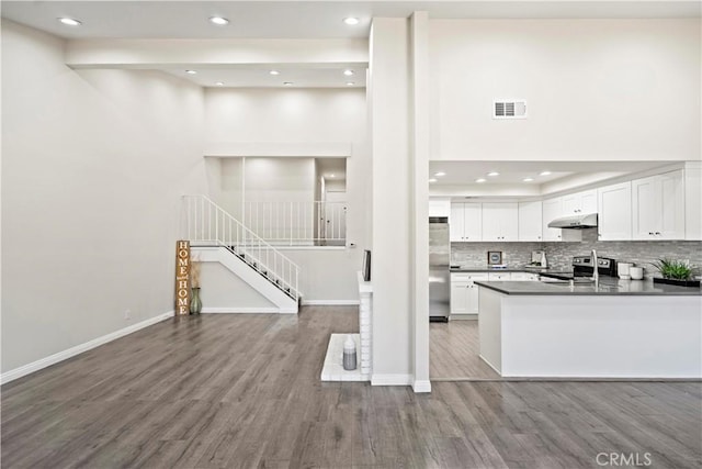 4366 Fairview Ave Unit 6, Arcadia, CA 91007 - kitchen with wood finished floors, white cabinetry, stainless steel appliances, recessed lighting, and decorative backsplash