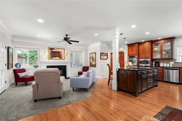 45 Covell Park Ave, Chico, CA 95926 - living area with light wood-style flooring, recessed lighting, ceiling fan, a fireplace, and crown molding