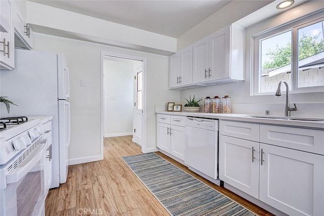 426 S Broadway, Redondo Beach, CA 90277 - kitchen featuring white appliances, white cabinets, light countertops, and light wood-style floors