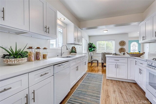 426 S Broadway, Redondo Beach, CA 90277 - kitchen with white appliances, light wood-style floors, white cabinets, light countertops, and a peninsula