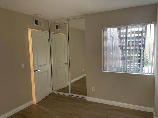 17189 W Bernardo Dr W Unit 103, San Diego, CA 92127 - unfurnished bedroom with wood finished floors and a closet
