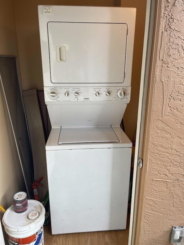 17189 W Bernardo Dr W Unit 103, San Diego, CA 92127 - laundry area featuring stacked washer and clothes dryer and wood finished floors