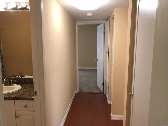 17189 W Bernardo Dr W Unit 103, San Diego, CA 92127 - hallway with a sink and dark wood-type flooring