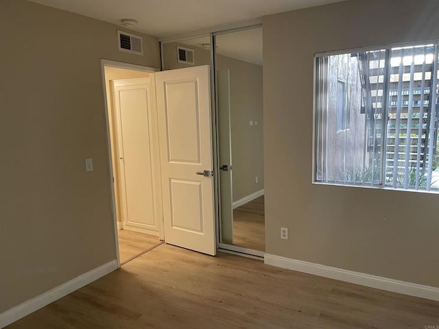 17189 W Bernardo Dr W Unit 103, San Diego, CA 92127 - unfurnished bedroom featuring wood finished floors and a closet
