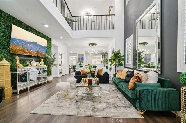 12400 Sarah Ct, El Monte, CA 91732 - living area featuring a towering ceiling, wood finished floors, a chandelier, and recessed lighting