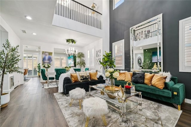 12400 Sarah Ct, El Monte, CA 91732 - living room with wood finished floors, a chandelier, a high ceiling, and recessed lighting