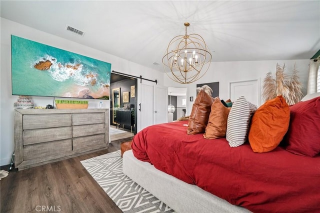 12400 Sarah Ct, El Monte, CA 91732 - bedroom with wood finished floors, a barn door, and a chandelier
