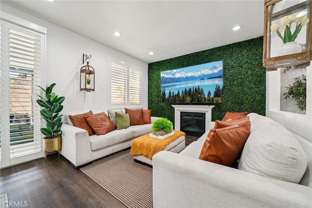 12400 Sarah Ct, El Monte, CA 91732 - living room featuring recessed lighting, dark wood finished floors, an accent wall, and a glass covered fireplace