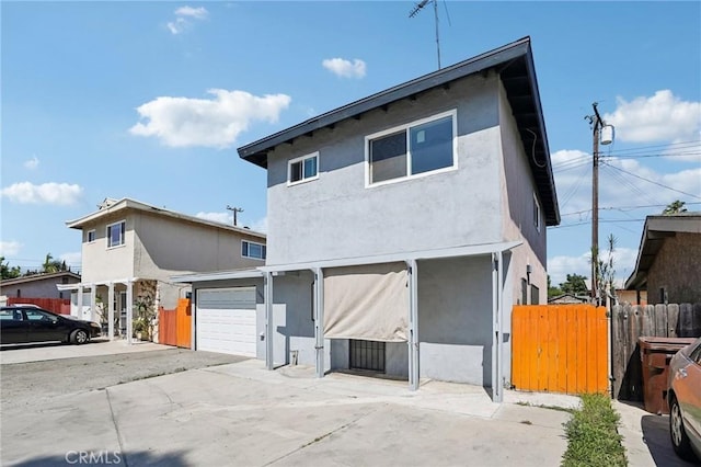 11052 1/2 Mcgirk Ave, El Monte, CA 91731 - view of front facade featuring stucco siding, concrete driveway, and an attached garage