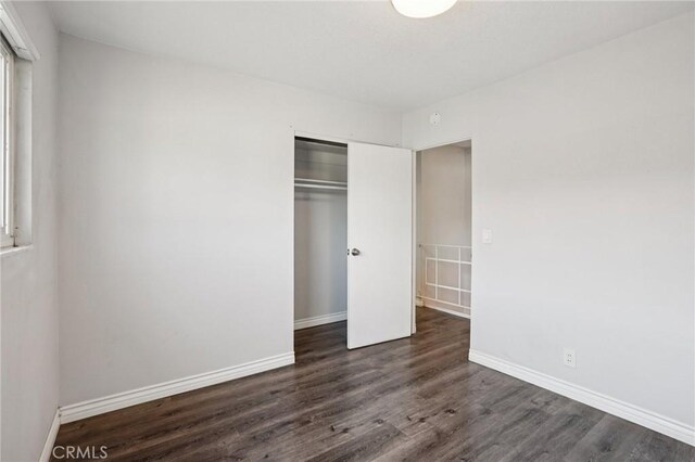 11052 1/2 Mcgirk Ave, El Monte, CA 91731 - unfurnished bedroom featuring a closet and dark wood-style flooring
