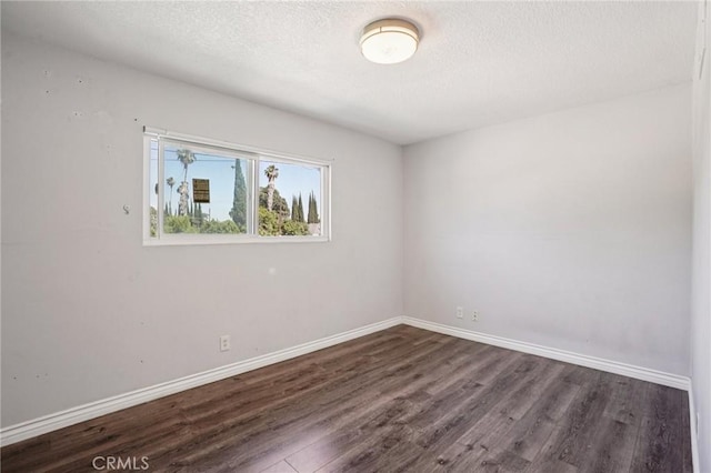 11052 1/2 Mcgirk Ave, El Monte, CA 91731 - unfurnished room with dark wood-style flooring and a textured ceiling