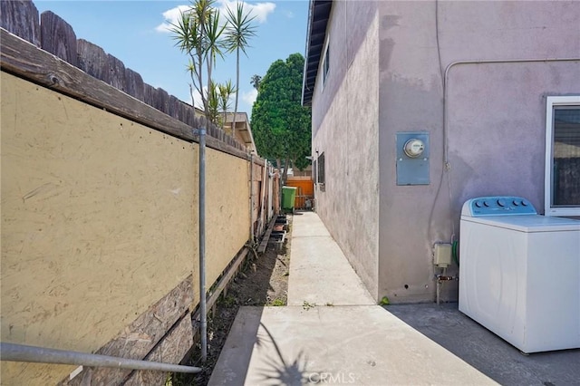 11052 1/2 Mcgirk Ave, El Monte, CA 91731 - view of side of home featuring washer / clothes dryer, stucco siding, and a patio