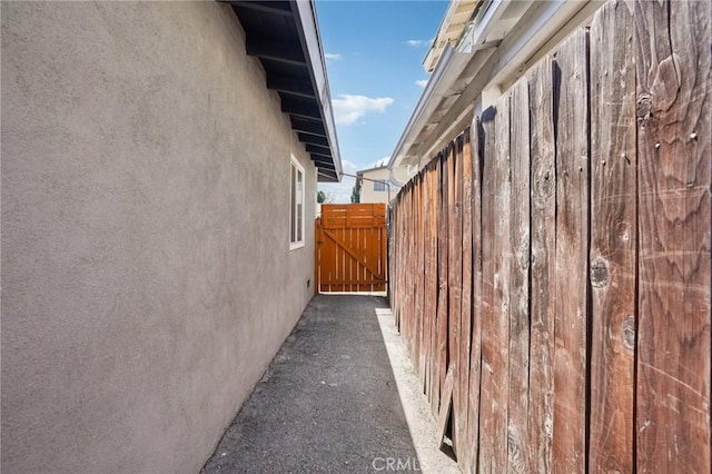 11052 1/2 Mcgirk Ave, El Monte, CA 91731 - view of side of property with stucco siding and a gate