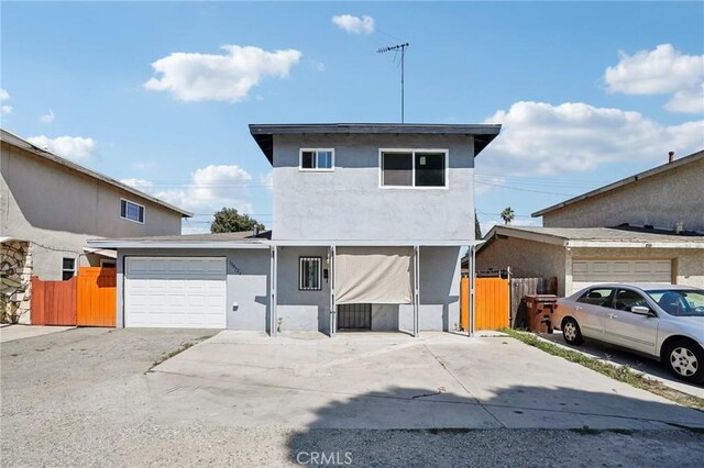 11052 1/2 Mcgirk Ave, El Monte, CA 91731 - view of front of property featuring an attached garage, stucco siding, and concrete driveway