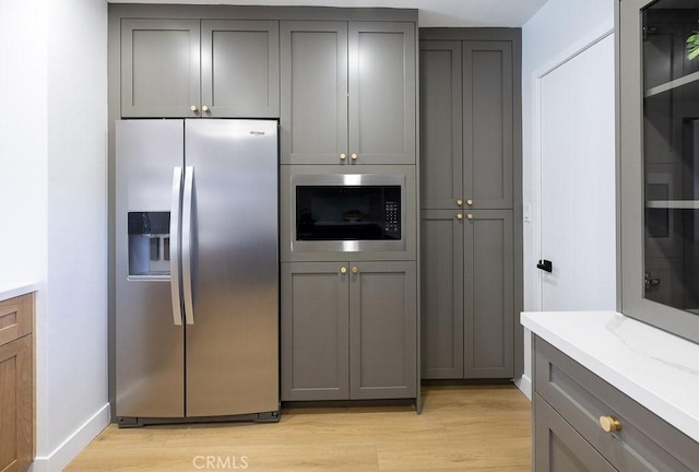 7830 Fairchild Ave, Winnetka, CA 91306 - kitchen featuring stainless steel appliances, gray cabinetry, and light wood-type flooring