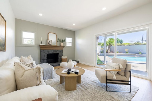 7830 Fairchild Ave, Winnetka, CA 91306 - living area featuring light wood-style floors, plenty of natural light, a stone fireplace, and recessed lighting