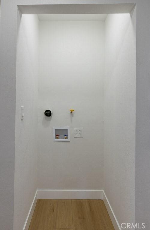 7830 Fairchild Ave, Winnetka, CA 91306 - laundry room with light wood-style floors and hookup for a washing machine