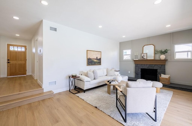 7830 Fairchild Ave, Winnetka, CA 91306 - living room with recessed lighting, healthy amount of natural light, wood finished floors, and a stone fireplace