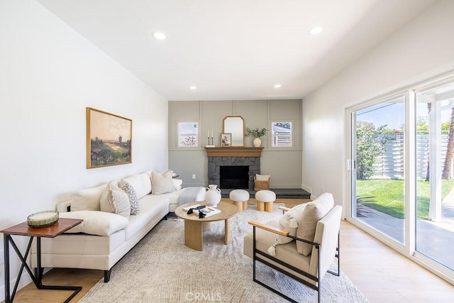 7830 Fairchild Ave, Winnetka, CA 91306 - living room featuring light wood-style floors, healthy amount of natural light, recessed lighting, and a fireplace