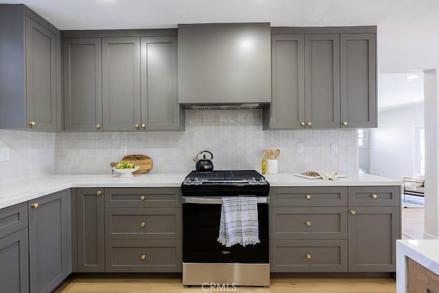 7830 Fairchild Ave, Winnetka, CA 91306 - kitchen with stainless steel gas stove, gray cabinetry, light countertops, and tasteful backsplash