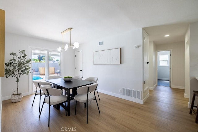 7830 Fairchild Ave, Winnetka, CA 91306 - dining space with light wood-style floors and a chandelier
