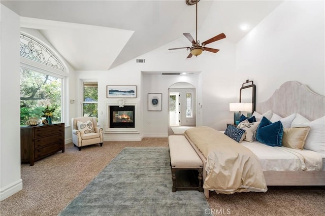 45200 Oak Manor Ct, Temecula, CA 92590 - carpeted bedroom featuring multiple windows, arched walkways, high vaulted ceiling, a glass covered fireplace, and ceiling fan