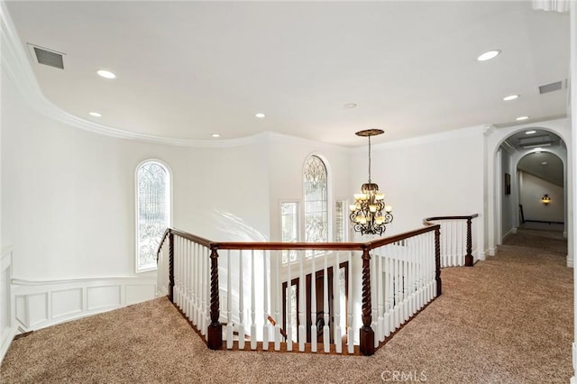 45200 Oak Manor Ct, Temecula, CA 92590 - hallway featuring carpet flooring, arched walkways, an upstairs landing, ornamental molding, and a chandelier