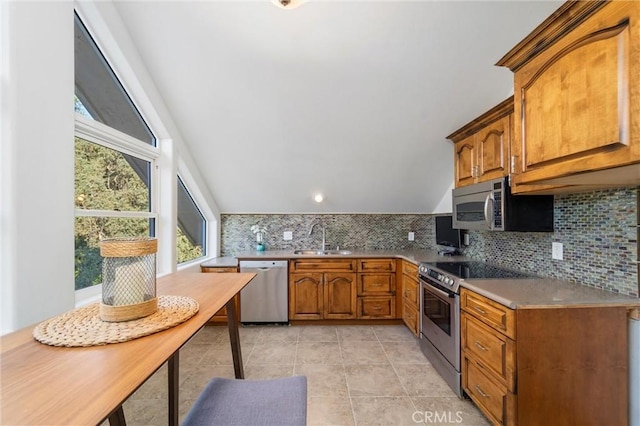 45200 Oak Manor Ct, Temecula, CA 92590 - kitchen with stainless steel appliances, brown cabinets, decorative backsplash, light tile patterned floors, and lofted ceiling