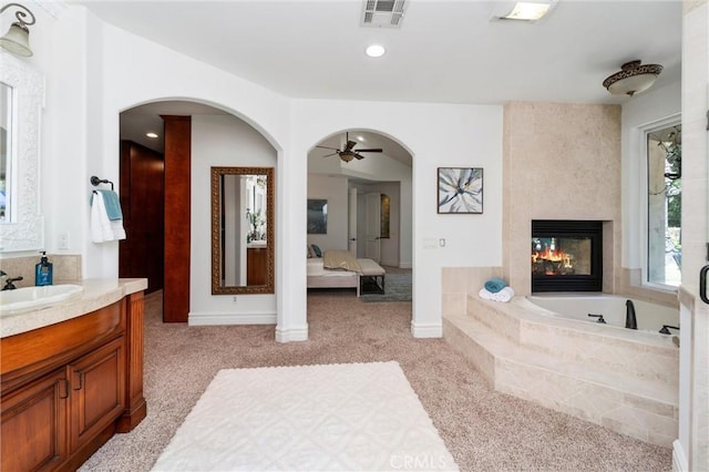 45200 Oak Manor Ct, Temecula, CA 92590 - full bathroom with vanity, a garden tub, a multi sided fireplace, ceiling fan, and ensuite bathroom