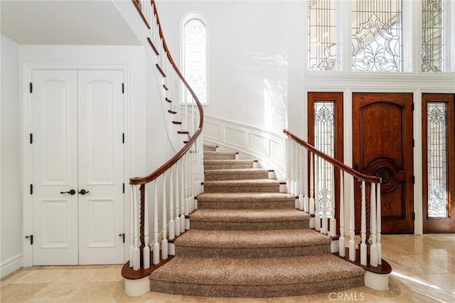 45200 Oak Manor Ct, Temecula, CA 92590 - foyer entrance with stairs, a decorative wall, a high ceiling, and wainscoting