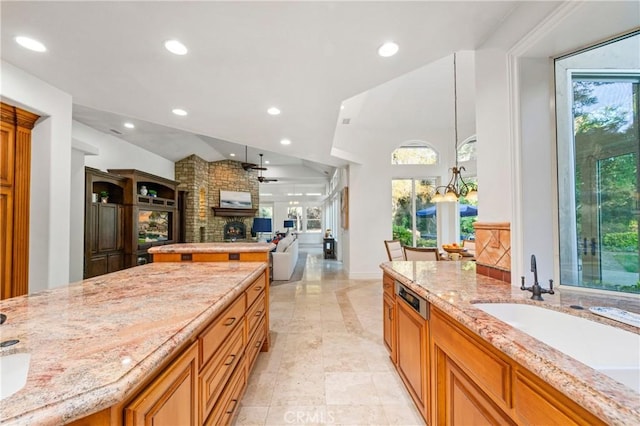 45200 Oak Manor Ct, Temecula, CA 92590 - kitchen featuring light stone countertops, recessed lighting, a large fireplace, open floor plan, and vaulted ceiling