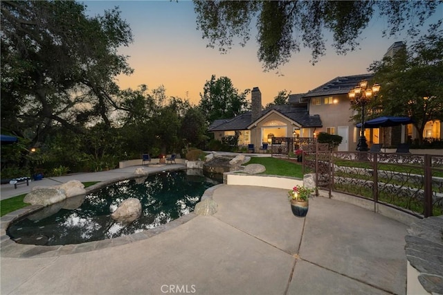 45200 Oak Manor Ct, Temecula, CA 92590 - pool at dusk featuring a patio and an outdoor pool