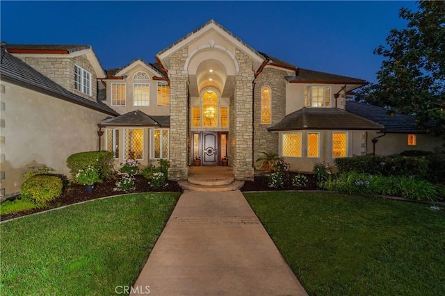 45200 Oak Manor Ct, Temecula, CA 92590 - view of front of home with stucco siding, a lawn, and stone siding