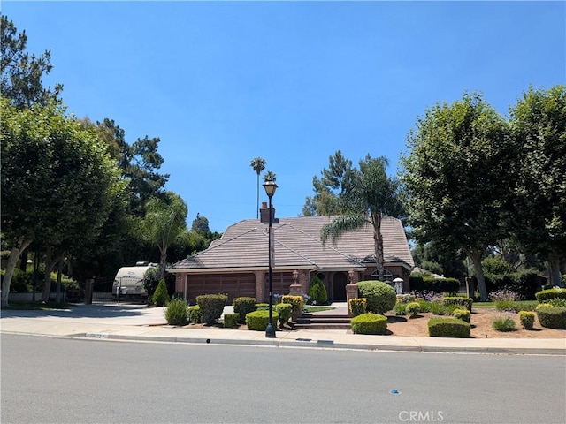 2622 Chauncy Pl, Riverside, CA 92506 - view of front facade featuring driveway, a garage, and a tiled roof