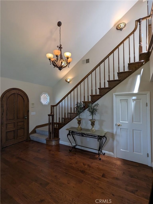 2622 Chauncy Pl, Riverside, CA 92506 - entrance foyer with stairs, a chandelier, wood finished floors, arched walkways, and lofted ceiling