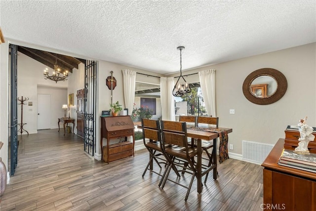 9292 Garden St, Rancho Cucamonga, CA 91701 - dining space with a chandelier, wood finished floors, and a textured ceiling
