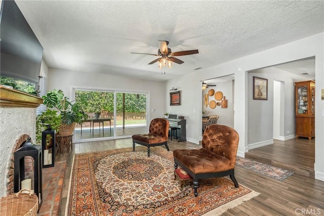 9292 Garden St, Rancho Cucamonga, CA 91701 - living room with a fireplace, ceiling fan, a textured ceiling, and wood finished floors