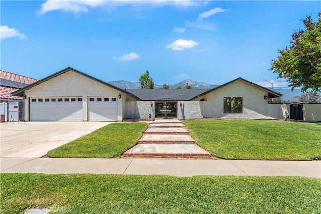 9292 Garden St, Rancho Cucamonga, CA 91701 - view of front of home featuring a garage, concrete driveway, a front lawn, a mountain view, and stucco siding