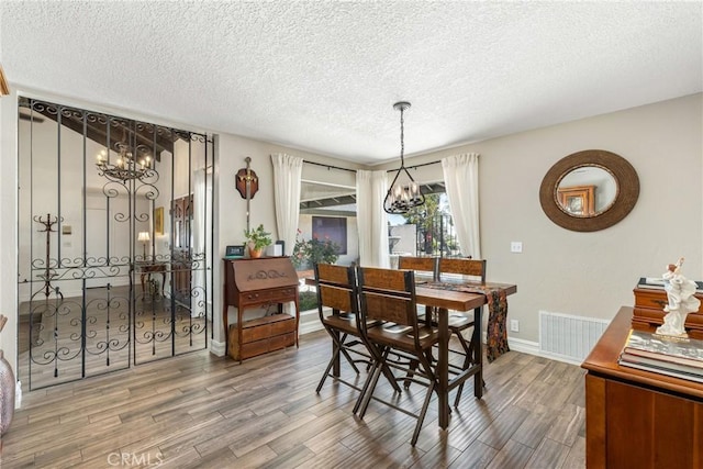 9292 Garden St, Rancho Cucamonga, CA 91701 - dining space with a chandelier, a textured ceiling, and wood finished floors