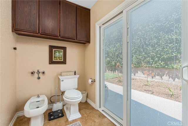9292 Garden St, Rancho Cucamonga, CA 91701 - bathroom featuring a bidet, plenty of natural light, and tile patterned flooring