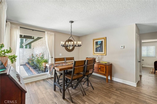 9292 Garden St, Rancho Cucamonga, CA 91701 - dining area with a chandelier, a textured ceiling, wood finished floors, and plenty of natural light