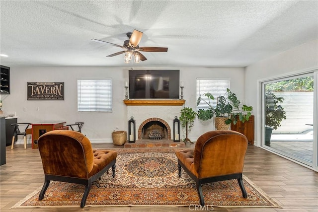 9292 Garden St, Rancho Cucamonga, CA 91701 - living room featuring a textured ceiling, wood finished floors, healthy amount of natural light, and a ceiling fan