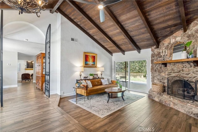 9292 Garden St, Rancho Cucamonga, CA 91701 - living area featuring a wooden ceiling with exposed beams, wood-type flooring, high vaulted ceiling, a stone fireplace, and a chandelier