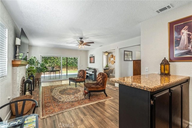 9292 Garden St, Rancho Cucamonga, CA 91701 - living room with a textured ceiling, a ceiling fan, wood finished floors, and a textured wall