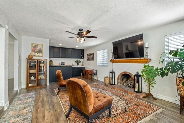 9292 Garden St, Rancho Cucamonga, CA 91701 - living area featuring a fireplace, a textured ceiling, a ceiling fan, and hardwood / wood-style flooring