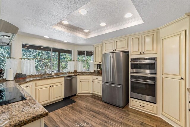 9292 Garden St, Rancho Cucamonga, CA 91701 - kitchen with appliances with stainless steel finishes, cream cabinets, a raised ceiling, a textured ceiling, and crown molding