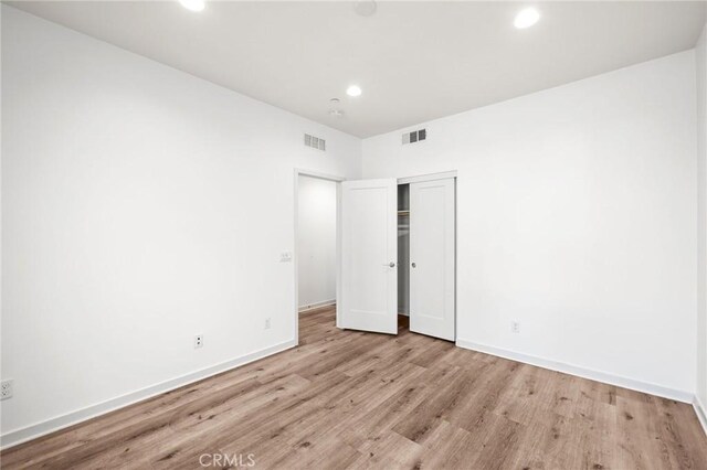 284 Novel, Irvine, CA 92618 - unfurnished bedroom featuring wood finished floors, recessed lighting, and a closet