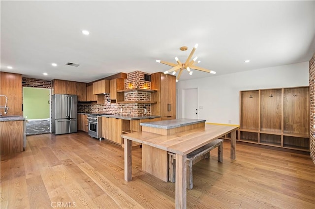 22526 Napa St, West Hills, CA 91304 - kitchen featuring appliances with stainless steel finishes, open shelves, light wood-style floors, backsplash, and recessed lighting