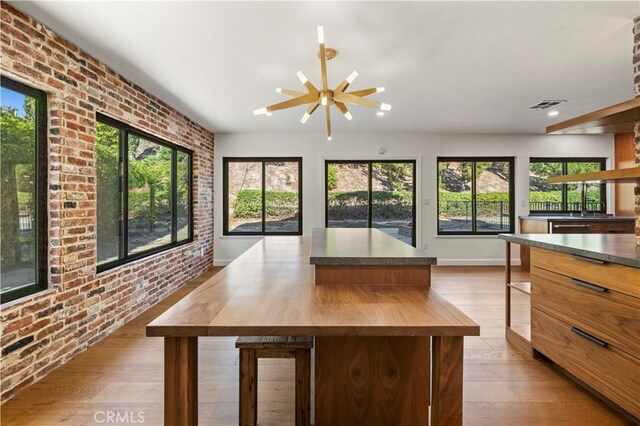 22526 Napa St, West Hills, CA 91304 - kitchen featuring brick wall, wood finished floors, a kitchen island, ceiling fan, and recessed lighting